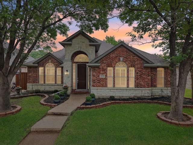 4118 Armistice Dr, Frisco, TX 75034 - view of front of property featuring stone siding, a shingled roof, a yard, and brick siding