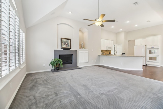 4118 Armistice Dr, Frisco, TX 75034 - unfurnished living room with high vaulted ceiling, a fireplace with raised hearth, visible vents, ceiling fan, and baseboards