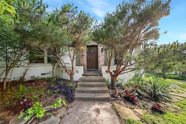 view of exterior entry with crawl space