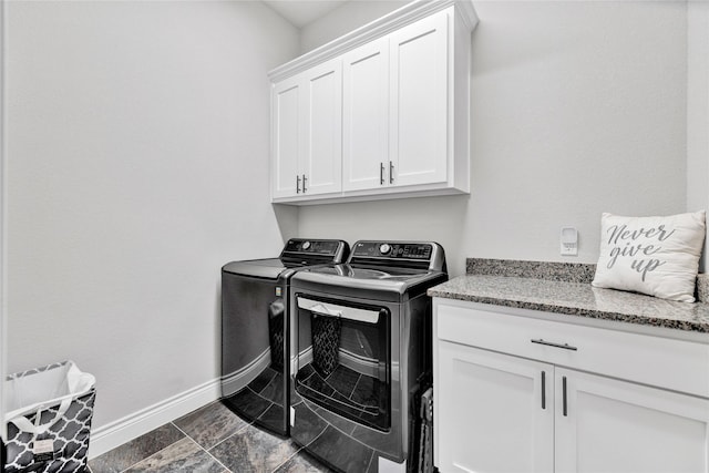 washroom featuring cabinet space, independent washer and dryer, and baseboards