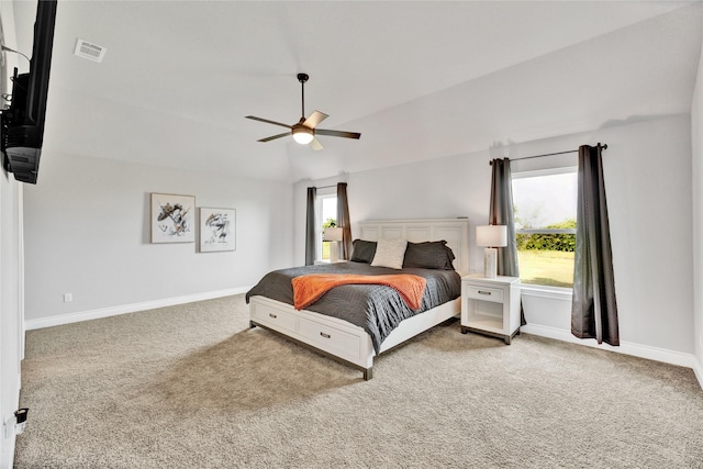 carpeted bedroom featuring baseboards, ceiling fan, lofted ceiling, and visible vents