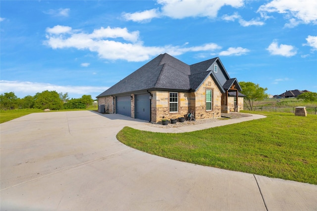 view of side of home featuring a lawn, a garage, concrete driveway, stone siding, and roof with shingles