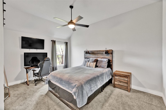 carpeted bedroom with lofted ceiling, baseboards, and a ceiling fan