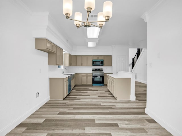 kitchen with an inviting chandelier, stainless steel appliances, light countertops, light wood-style floors, and ornamental molding