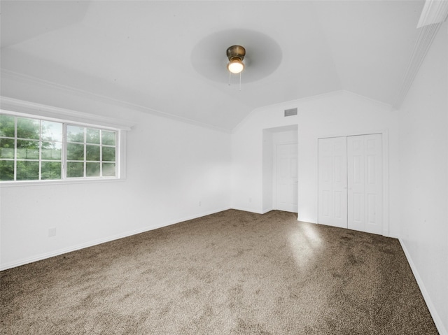 additional living space featuring carpet, baseboards, ceiling fan, visible vents, and vaulted ceiling