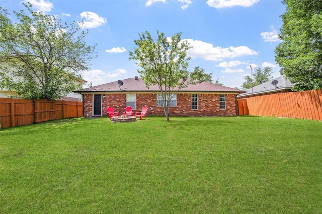 704 Loganwood Dr, Royse City, TX 75189 - rear view of property featuring an outdoor fire pit and brick siding