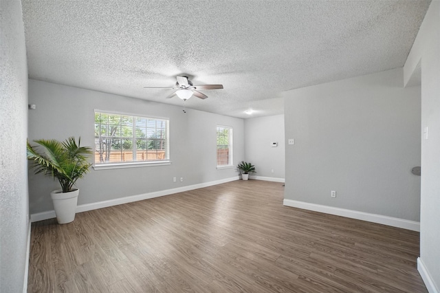 704 Loganwood Dr, Royse City, TX 75189 - empty room with a ceiling fan, wood finished floors, a textured ceiling, and baseboards