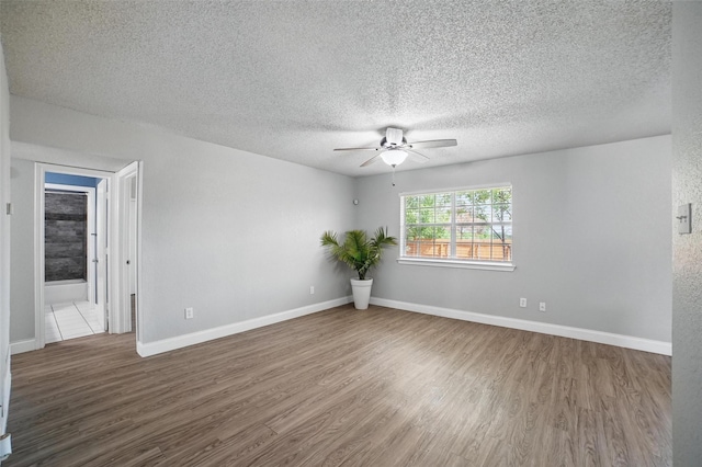 704 Loganwood Dr, Royse City, TX 75189 - unfurnished room featuring ceiling fan, wood finished floors, a textured ceiling, and baseboards