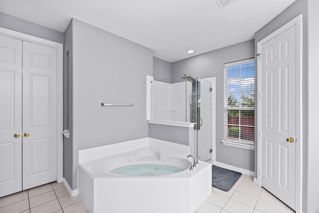 full bath featuring tile patterned flooring, a stall shower, a garden tub, baseboards, and recessed lighting