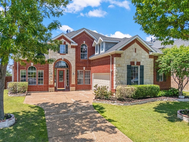 traditional-style house with stone siding, a front lawn, concrete driveway, and a garage