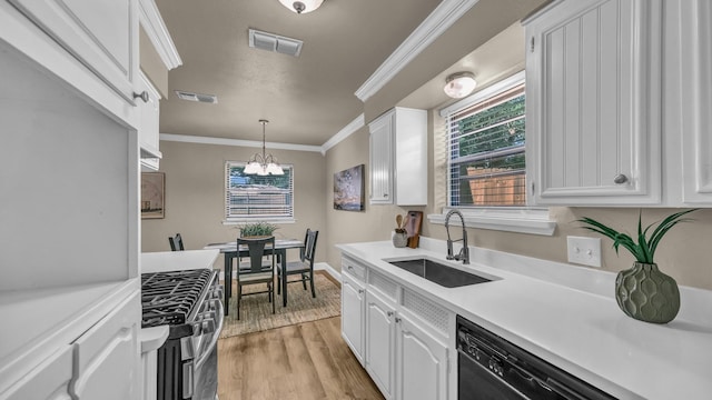 521 S Kate St, White Settlement, TX 76108 - kitchen with a sink, stainless steel gas range oven, ornamental molding, visible vents, and a chandelier