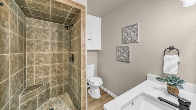 521 S Kate St, White Settlement, TX 76108 - full bath featuring vanity, toilet, wood finished floors, and tiled shower
