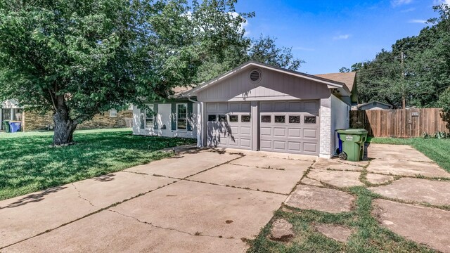 521 S Kate St, White Settlement, TX 76108 - ranch-style home with fence, an attached garage, concrete driveway, stone siding, and a front lawn
