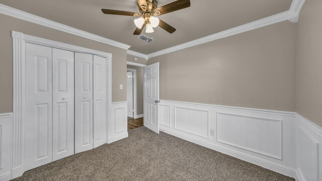 521 S Kate St, White Settlement, TX 76108 - unfurnished bedroom with a closet, carpet, wainscoting, visible vents, and crown molding