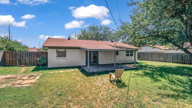 521 S Kate St, White Settlement, TX 76108 - rear view of house featuring a yard, a patio, and french doors