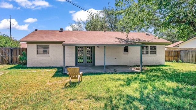 521 S Kate St, White Settlement, TX 76108 - rear view of property featuring a yard, a patio, french doors, and a fenced backyard