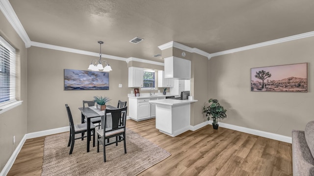 521 S Kate St, White Settlement, TX 76108 - dining space with a notable chandelier, baseboards, ornamental molding, visible vents, and light wood-style floors