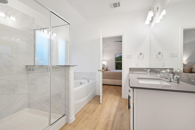 4025 Wild Turkey Dr, Hickory Creek, TX 75065 - ensuite bathroom featuring wood finished floors, a shower stall, double vanity, and a garden tub