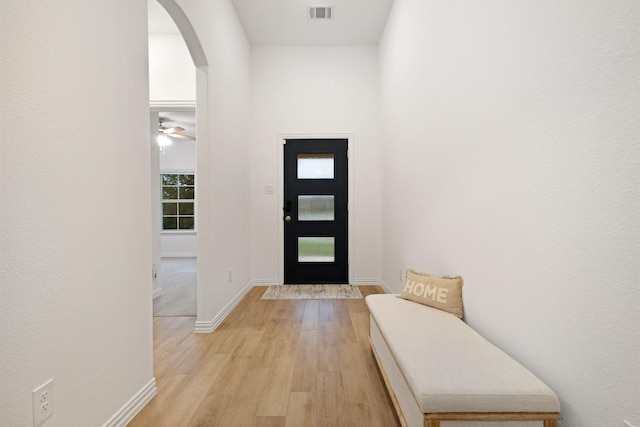 4025 Wild Turkey Dr, Hickory Creek, TX 75065 - doorway with arched walkways, light wood finished floors, and baseboards