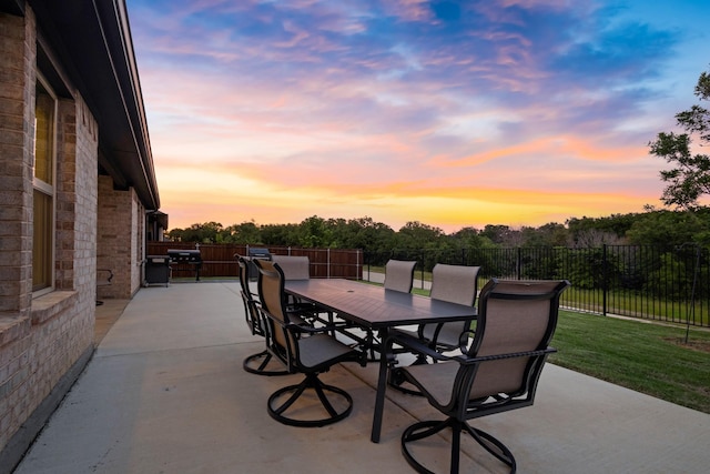 4025 Wild Turkey Dr, Hickory Creek, TX 75065 - patio terrace at dusk with outdoor dining area and fence