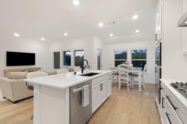 4025 Wild Turkey Dr, Hickory Creek, TX 75065 - kitchen featuring appliances with stainless steel finishes, a sink, open floor plan, a center island with sink, and recessed lighting