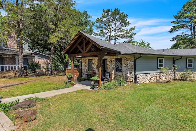 2204 County Road 1570, Alba, TX 75410 - view of front of home with stone siding, a front yard, and a shingled roof