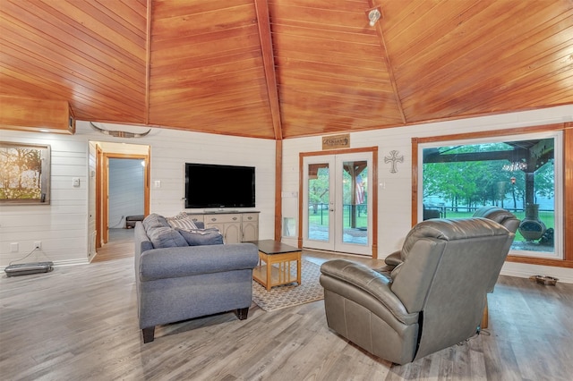 2204 County Road 1570, Alba, TX 75410 - living room featuring wood finished floors, wooden walls, vaulted ceiling, and baseboards