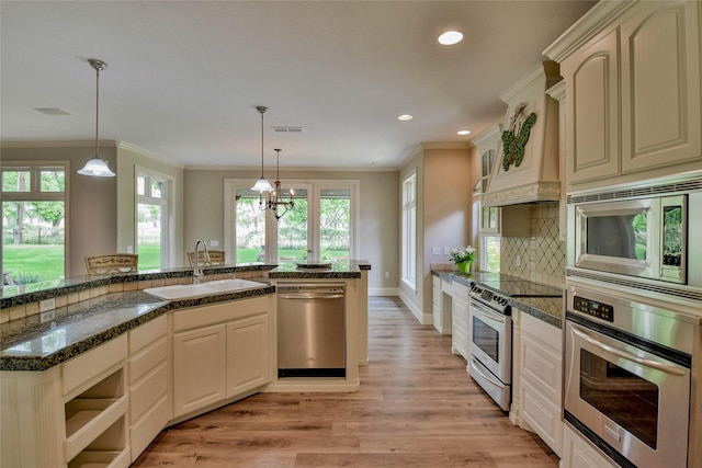 kitchen featuring a sink, light wood-type flooring, visible vents, appliances with stainless steel finishes, and ornamental molding