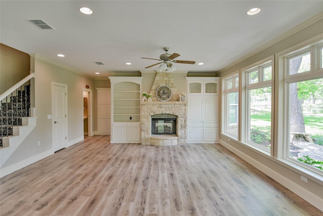 unfurnished living room featuring ornamental molding, visible vents, light wood finished floors, a ceiling fan, and baseboards