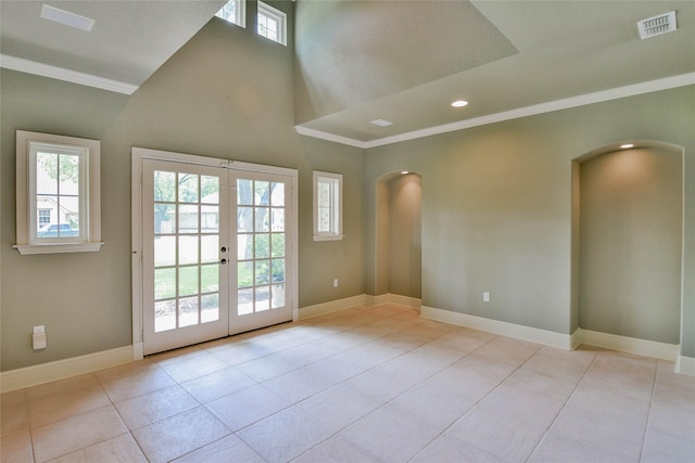 doorway to outside featuring arched walkways, tile patterned floors, and crown molding