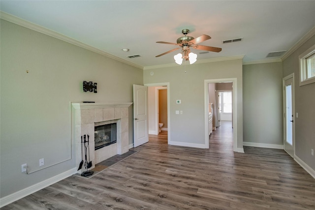 unfurnished living room featuring ceiling fan, ornamental molding, visible vents, and dark wood finished floors
