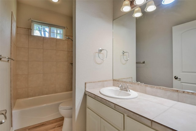 full bathroom with vanity, toilet, shower / bathtub combination, and wood finished floors