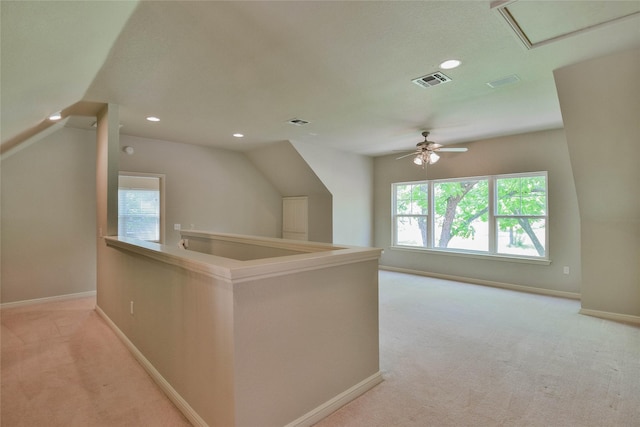 additional living space with baseboards, recessed lighting, visible vents, and light colored carpet