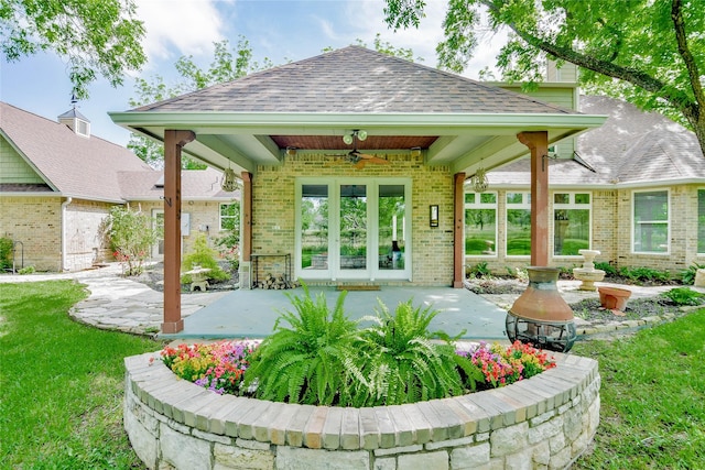 exterior space with a ceiling fan and french doors