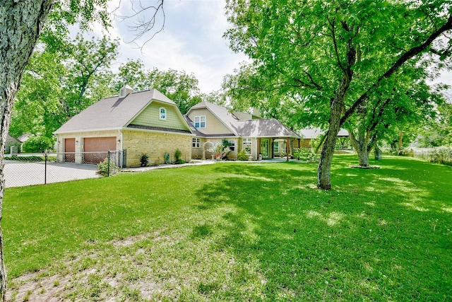 view of front of property with fence, brick siding, a garage, a front yard, and a chimney