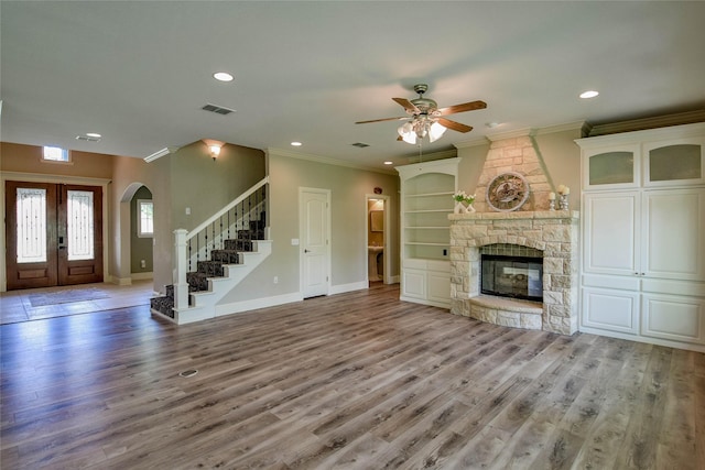 unfurnished living room featuring wood finished floors, visible vents, recessed lighting, stairway, and a ceiling fan