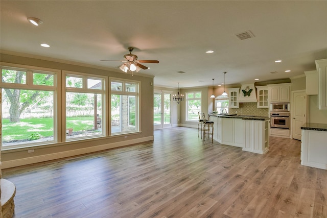 kitchen with ornamental molding, dark countertops, visible vents, and appliances with stainless steel finishes