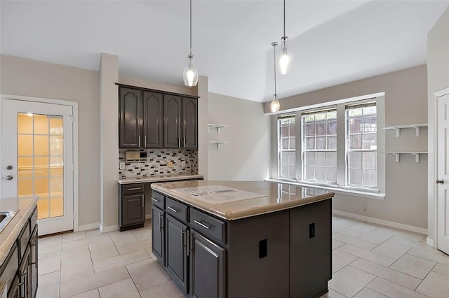 1424 Indian Spgs, Carrollton, TX 75007 - kitchen with light tile patterned floors, a center island, white electric cooktop, pendant lighting, and decorative backsplash