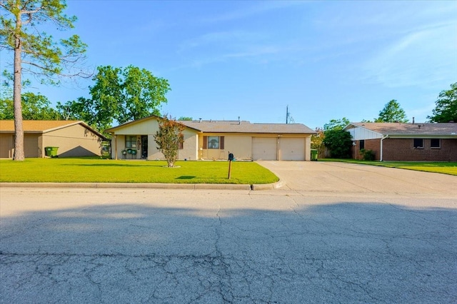 ranch-style home with a front yard, an attached garage, and driveway