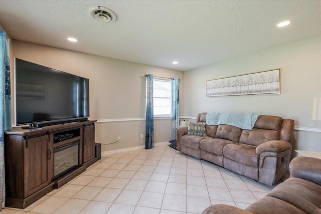 living area featuring light tile patterned floors, recessed lighting, and a textured ceiling