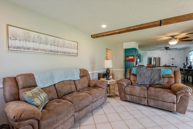 living room with light tile patterned floors, a textured ceiling, ceiling fan, beamed ceiling, and recessed lighting