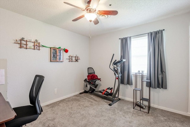 office space with ceiling fan, a textured ceiling, carpet floors, and baseboards