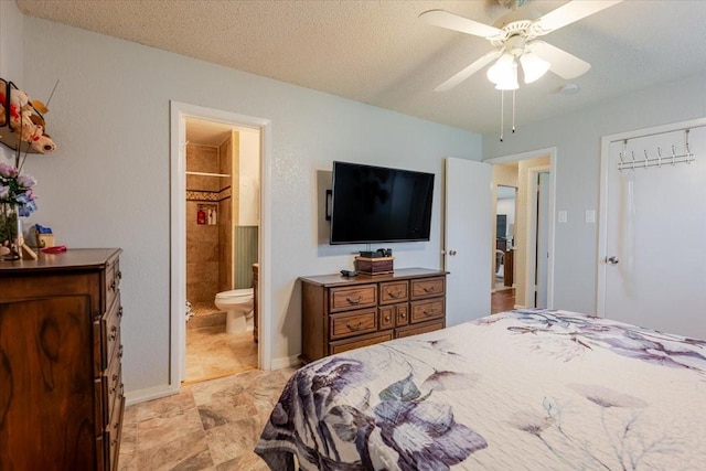bedroom with a closet, a textured ceiling, ensuite bathroom, baseboards, and ceiling fan
