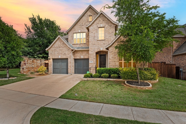 traditional-style house with concrete driveway, brick siding, a front lawn, and fence