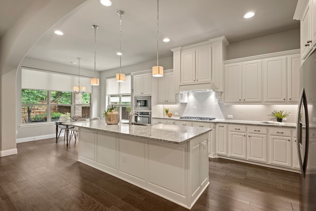 kitchen featuring stainless steel appliances, white cabinetry, and recessed lighting