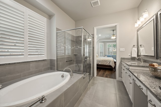 bathroom with vanity, visible vents, ceiling fan, a shower stall, and a garden tub