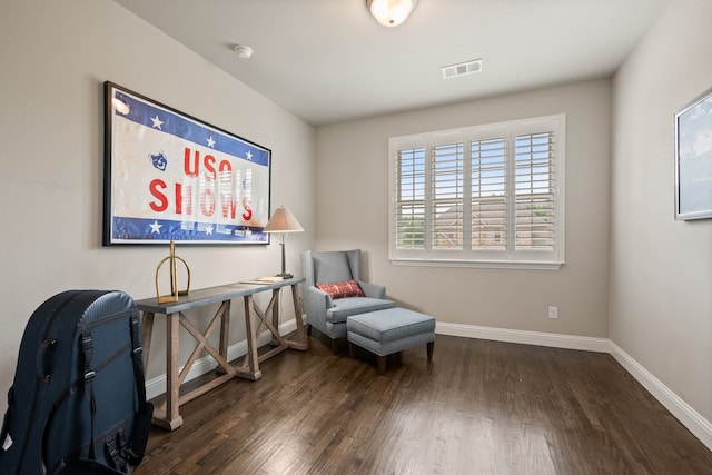 sitting room featuring wood finished floors, visible vents, and baseboards