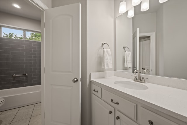 bathroom featuring tile patterned floors, tub / shower combination, and vanity
