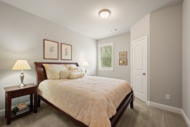 carpeted bedroom featuring baseboards and visible vents