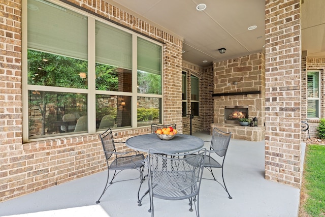 view of patio / terrace with an outdoor stone fireplace